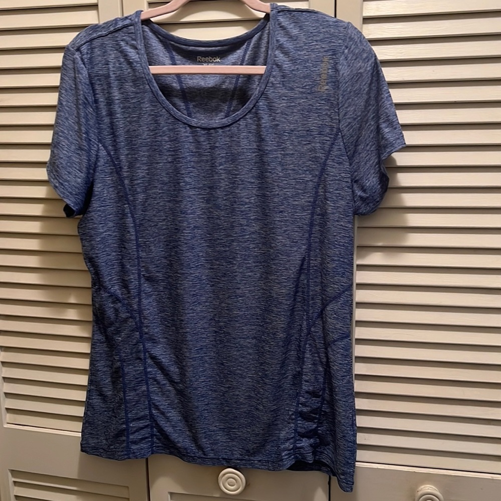 Women’s Blue workout T shirt. Reebok XL. Polyester and Spandex.Slightly fitted.